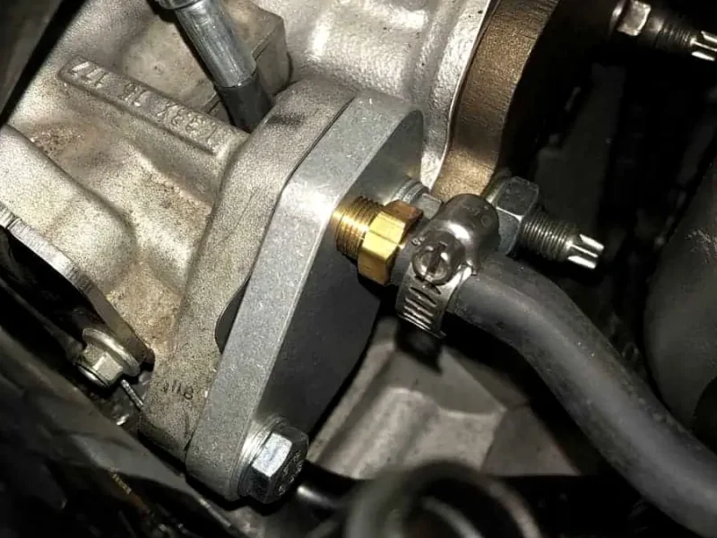 Emissions system plumbing in an engine bay